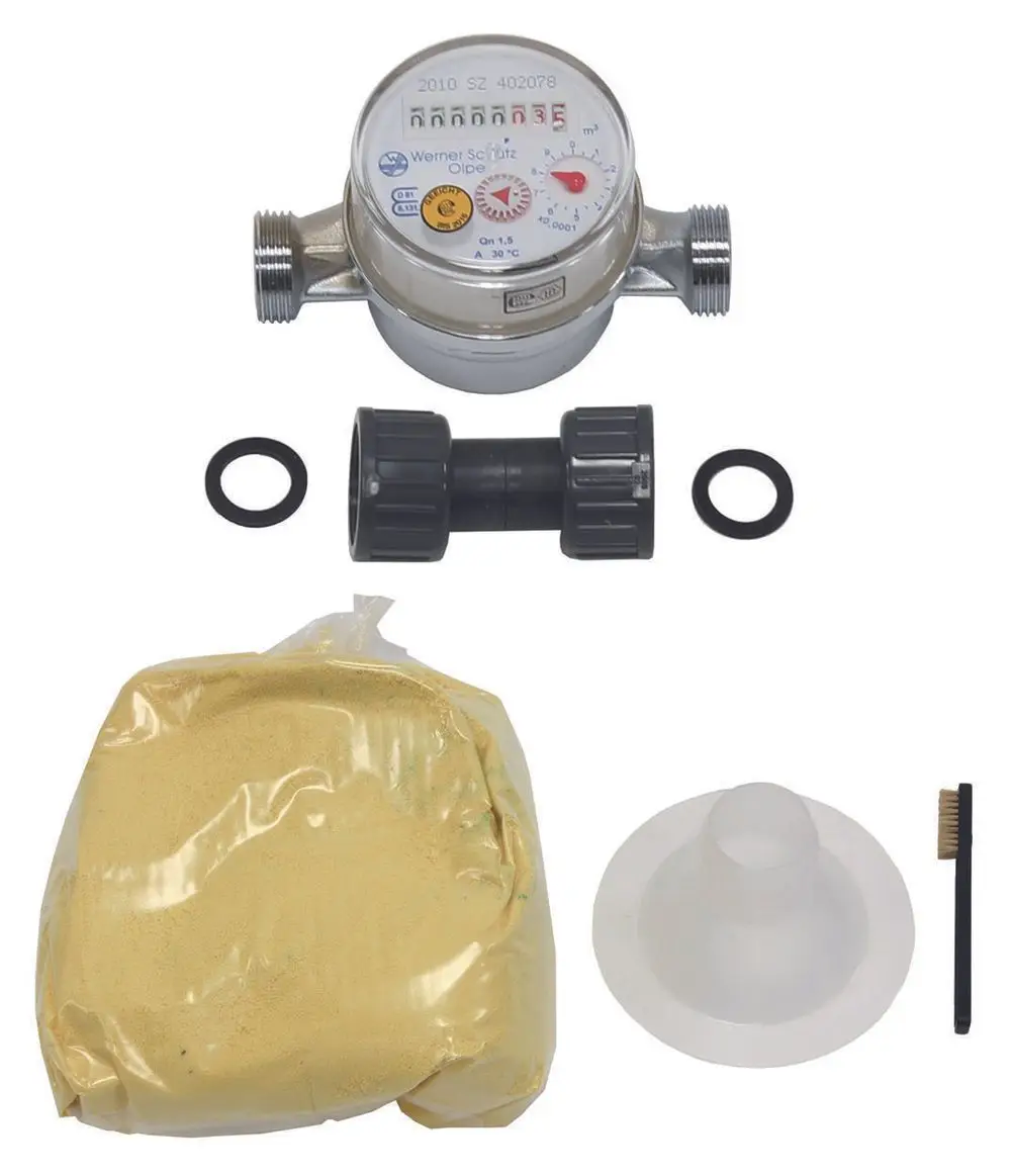 Wasserzähler mit Zubehör, bestehend aus einem Zähler, Anschlussstück, Dichtungen, einer Packung Gel und einer Bürste. Marke Vaillant deutlich erkennbar.